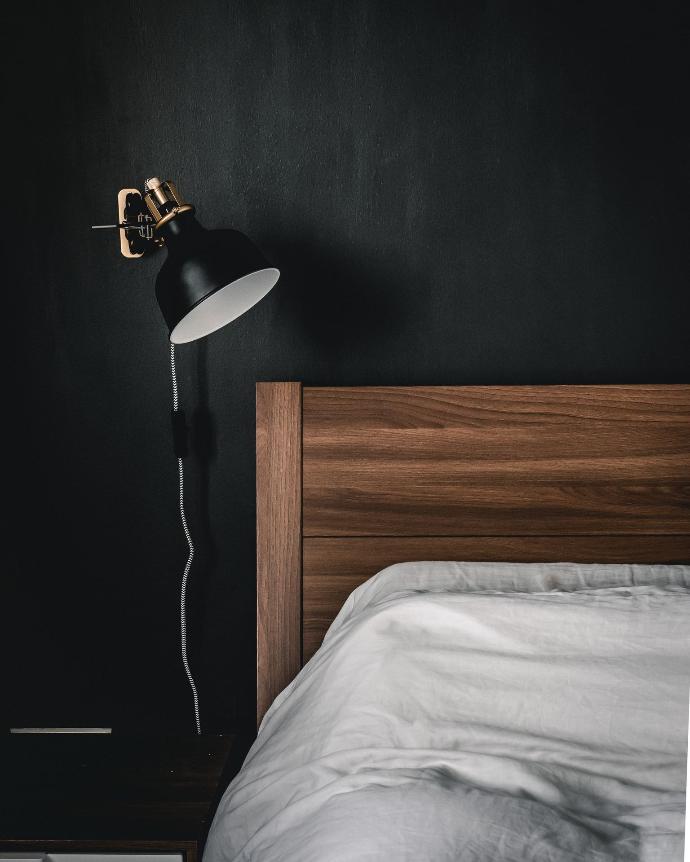 black and white table lamp on brown wooden nightstand